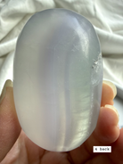 yttrium fluorite palm stone #4 back view with lavender and clear color banding with gentle translucency