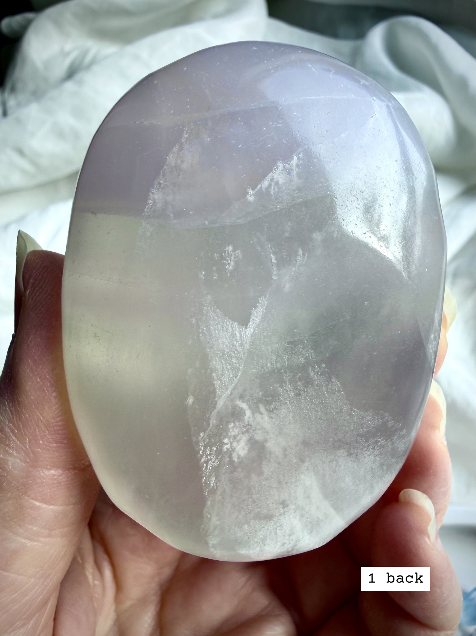 yttrium fluorite palm stone #1 back view with natural inclusions and soft green lavender color zoning