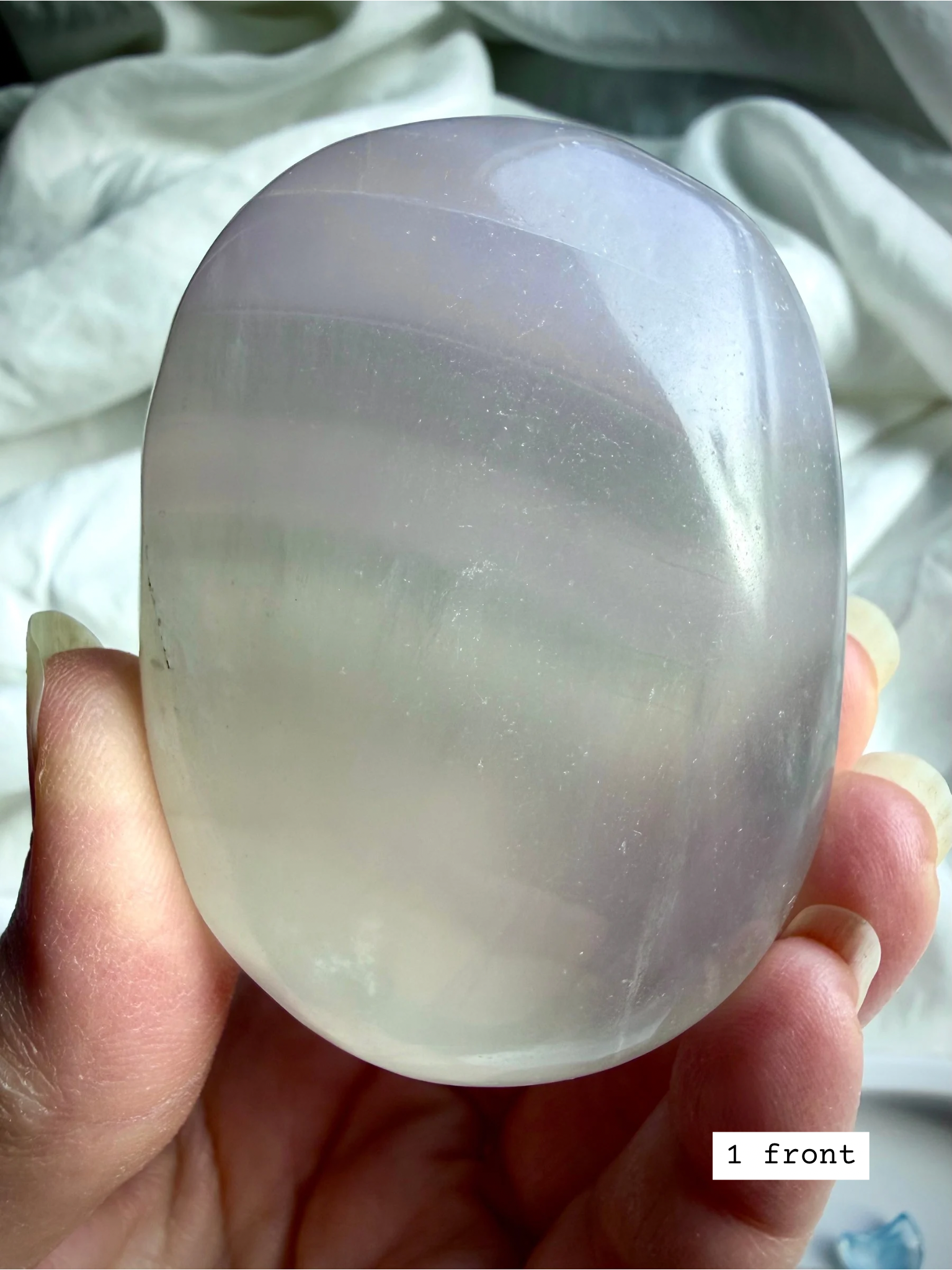 yttrium fluorite palm stone #1 front view showing pastel banding and translucent polish for clarity and intuition