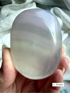 yttrium fluorite palm stone #1 front view showing pastel banding and translucent polish for clarity and intuition