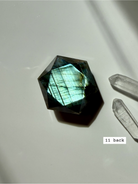 back view of polished faceted labradorite sacred geometry crystal with luminous blue flash number 11