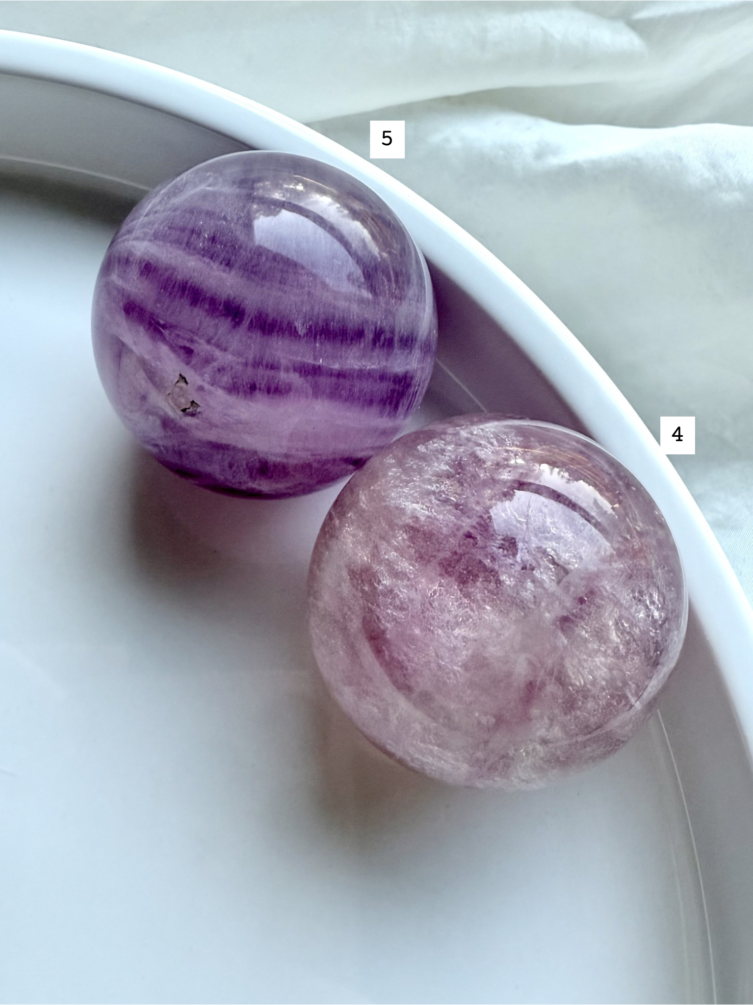 closeup of Silky Magenta Fluorite spheres showing layered lavender and blush crystal patterns