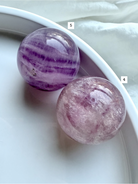 closeup of Silky Magenta Fluorite spheres showing layered lavender and blush crystal patterns