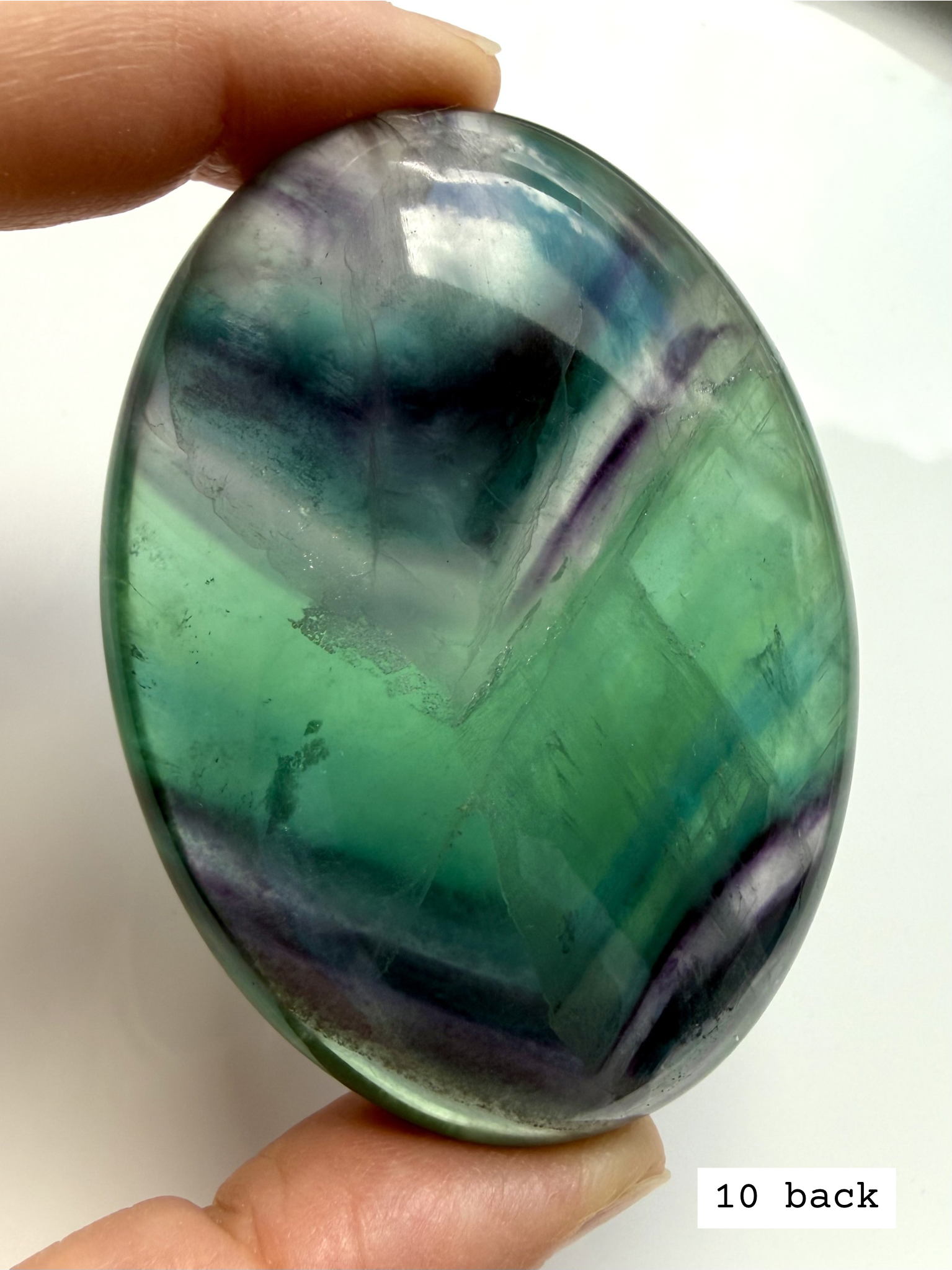 Teal fluorite palm stone #10 back view showing layered blue green banding and natural inclusions
