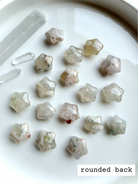 Flower Agate starfish carvings showing smooth rounded backs with natural blossom patterns and soft translucent glow