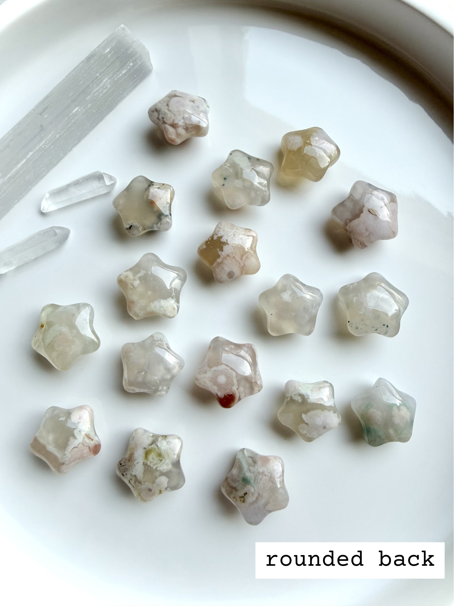 Flower Agate starfish carvings showing smooth rounded backs with natural blossom patterns and soft translucent glow