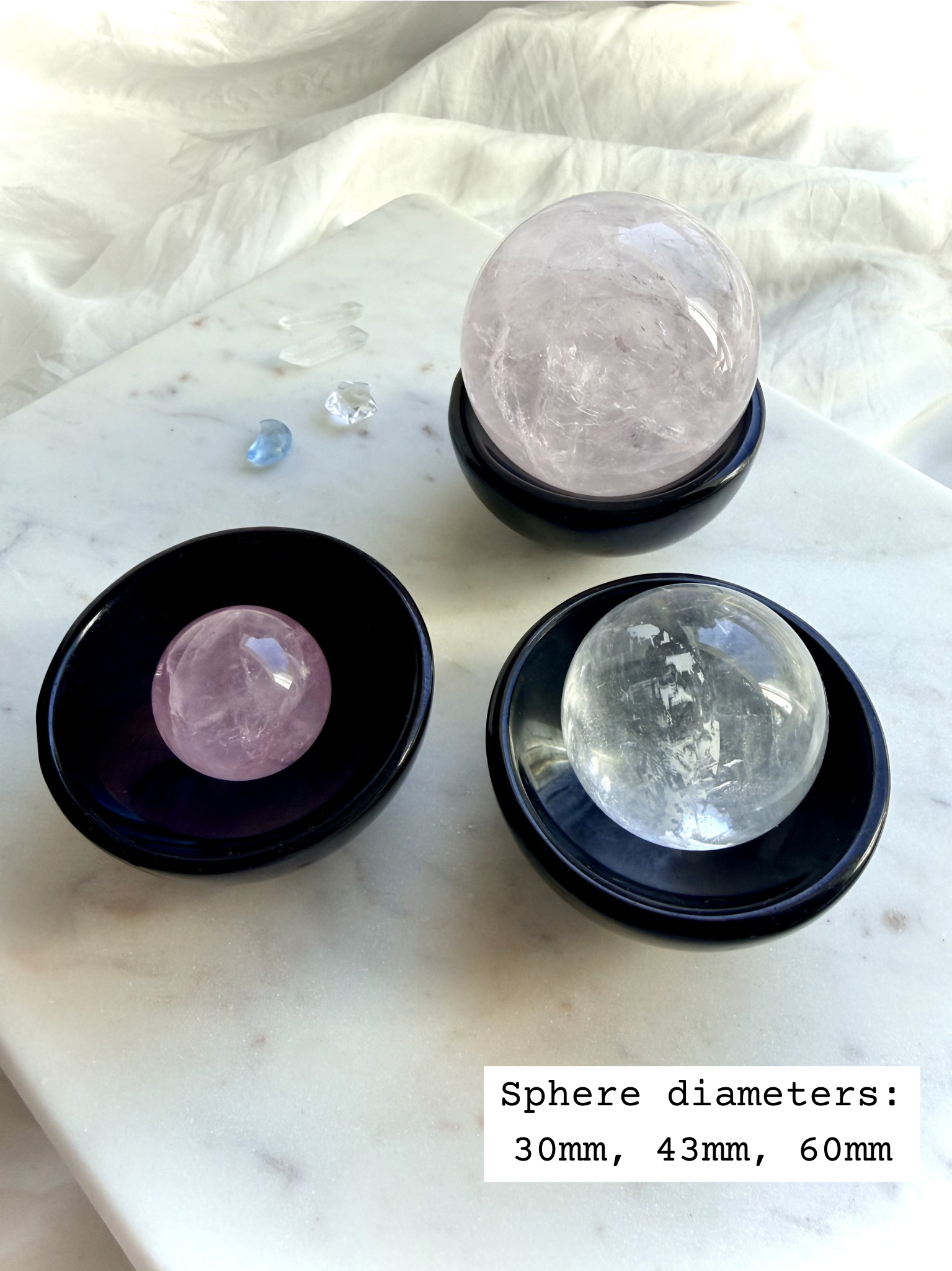 Black Obsidian crystal bowl displayed as a sphere holder showing 3 sizes of crystal balls marked 30mm, 43mm, and 60mm