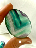 Rainbow Fluorite Palm Stone #3 with sea green and aqua ribbon banding and natural translucency