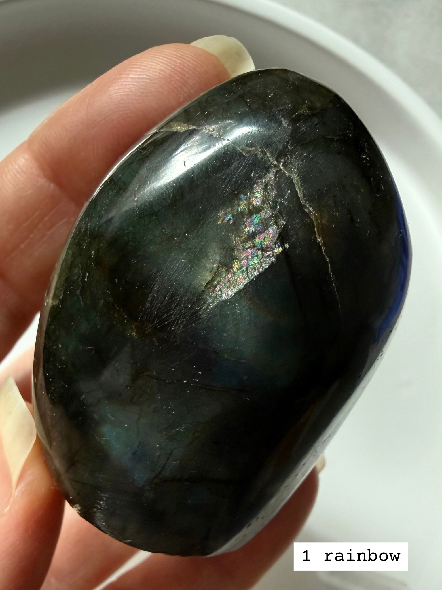 Closeup of polished labradorite freeform showing unique rainbow flash.