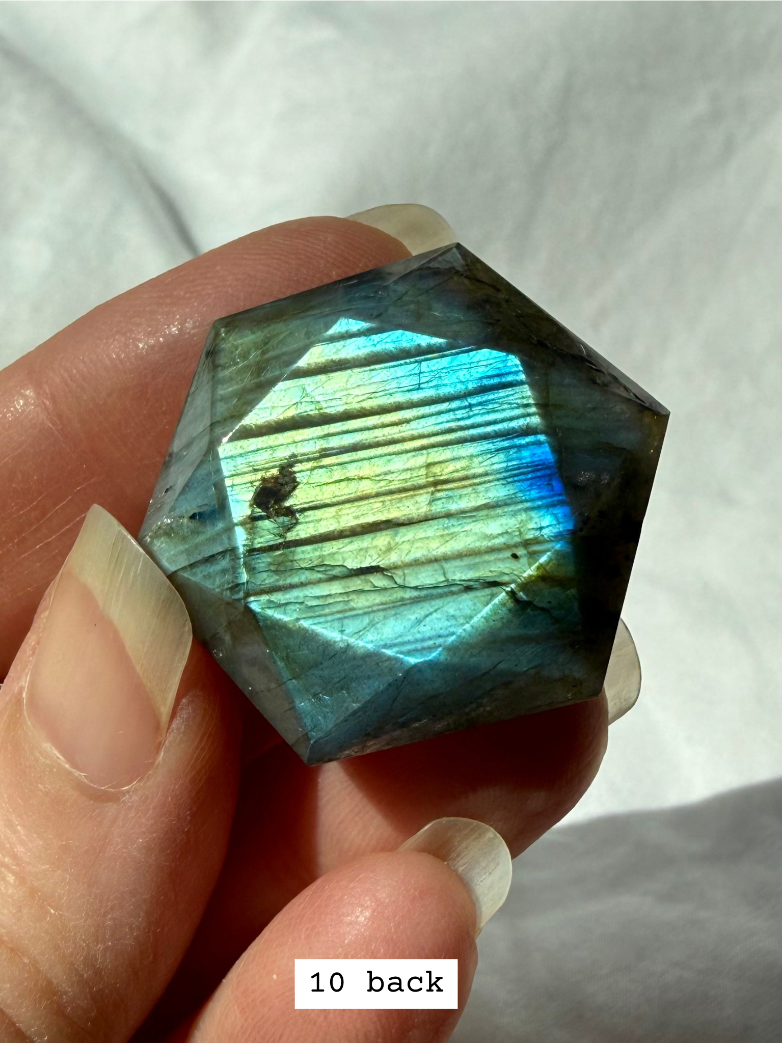 Faceted Labradorite hexagon crystal – sacred geometry hexagon for intuition, with luminous blue flash, back view