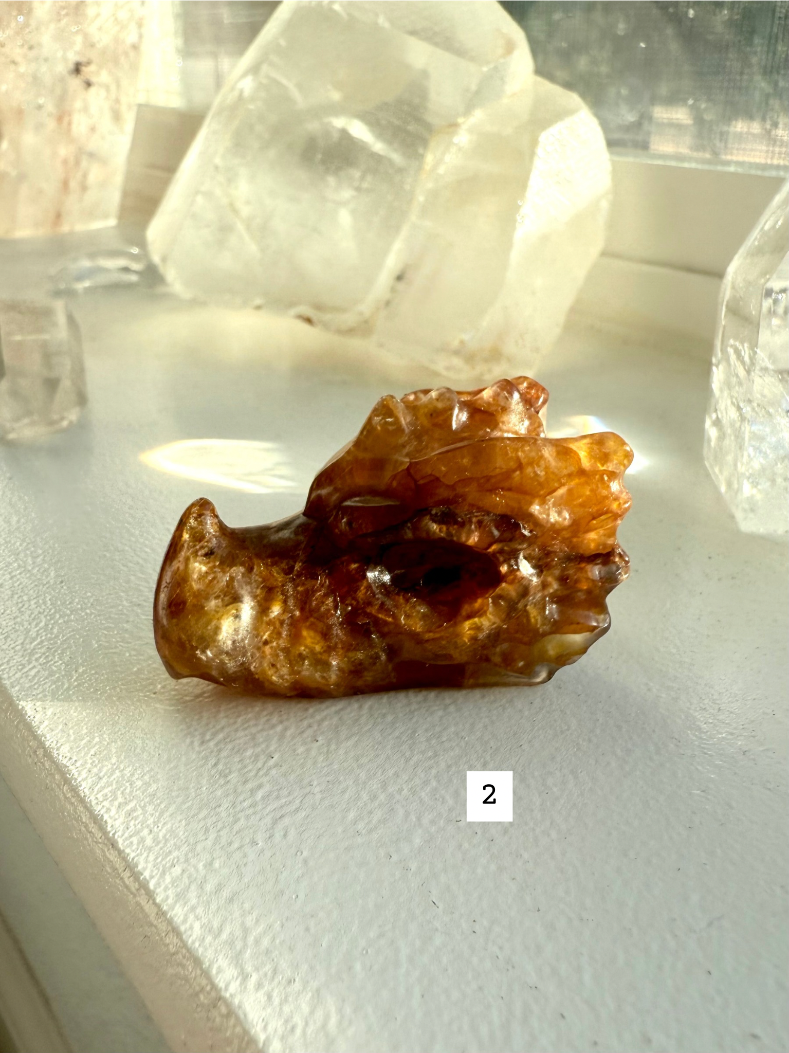 Dark golden-brown Golden Healer Quartz dragon head carving with hematite inclusions — gemstone figurine for energy work and spiritual protection.