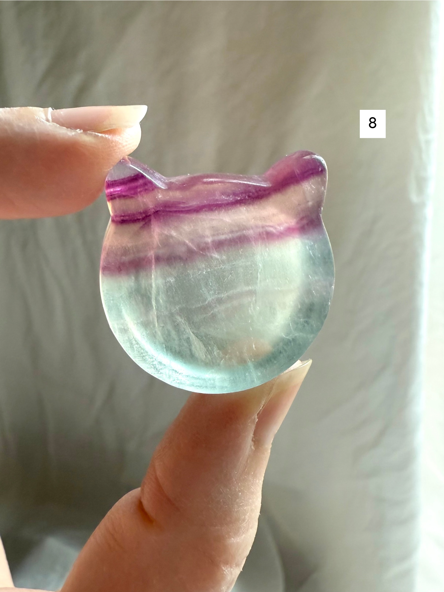 Fluorite cat-shaped crystal bowl held to the light – mini ring dish and jewelry holder