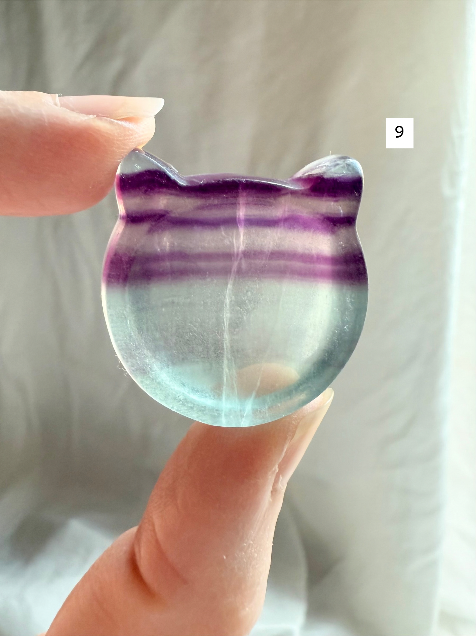 Fluorite cat-shaped crystal bowl held to the light – mini ring dish and jewelry holder