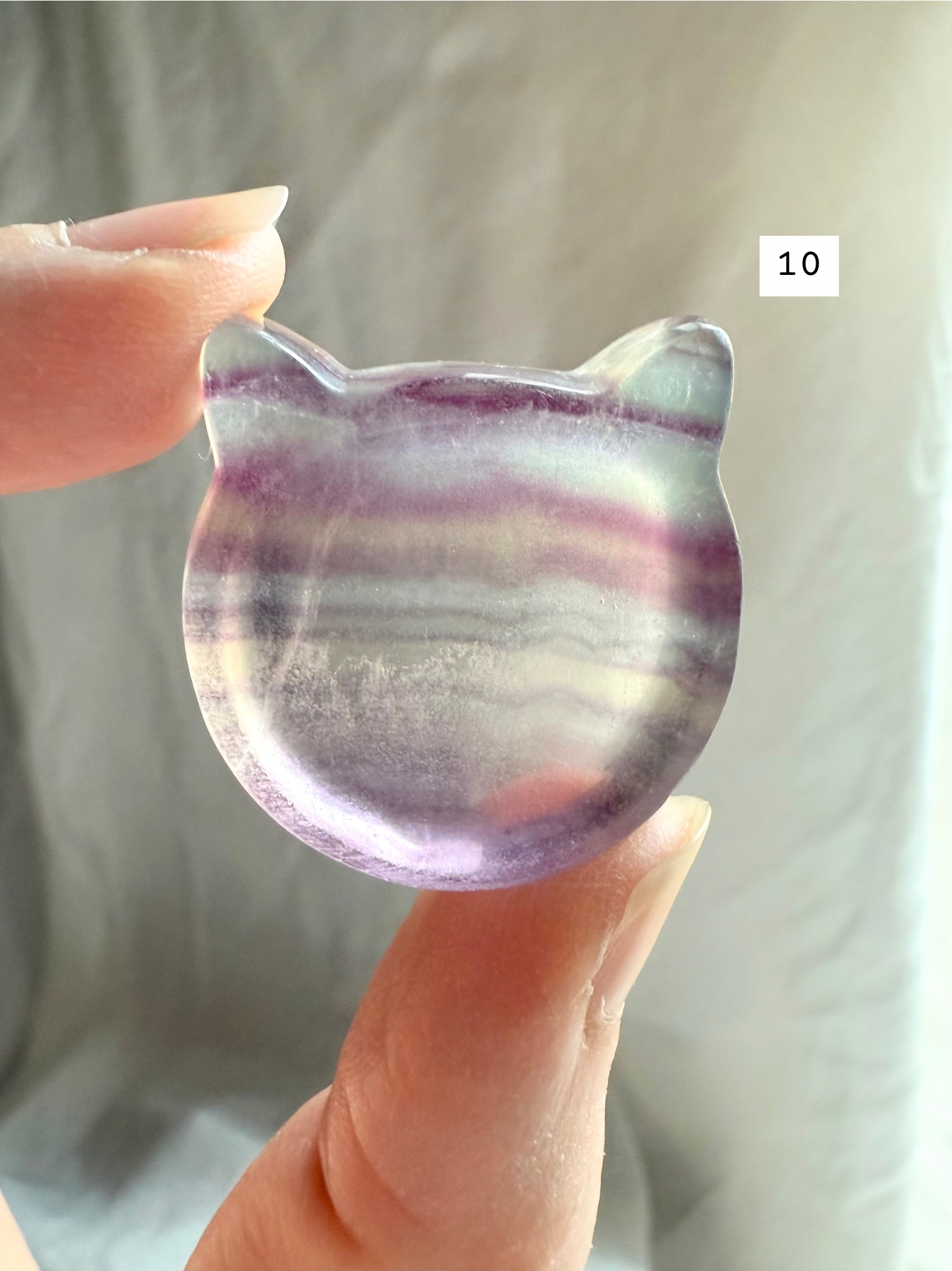 Fluorite cat-shaped crystal bowl held to the light – mini ring dish and jewelry holder
