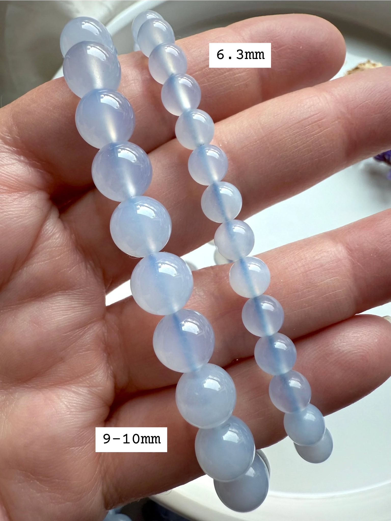 Blue Chalcedony stretch bracelets in 9–10mm and 6.3mm sizes — calming blue crystal beads for peace, communication, and throat chakra healing.