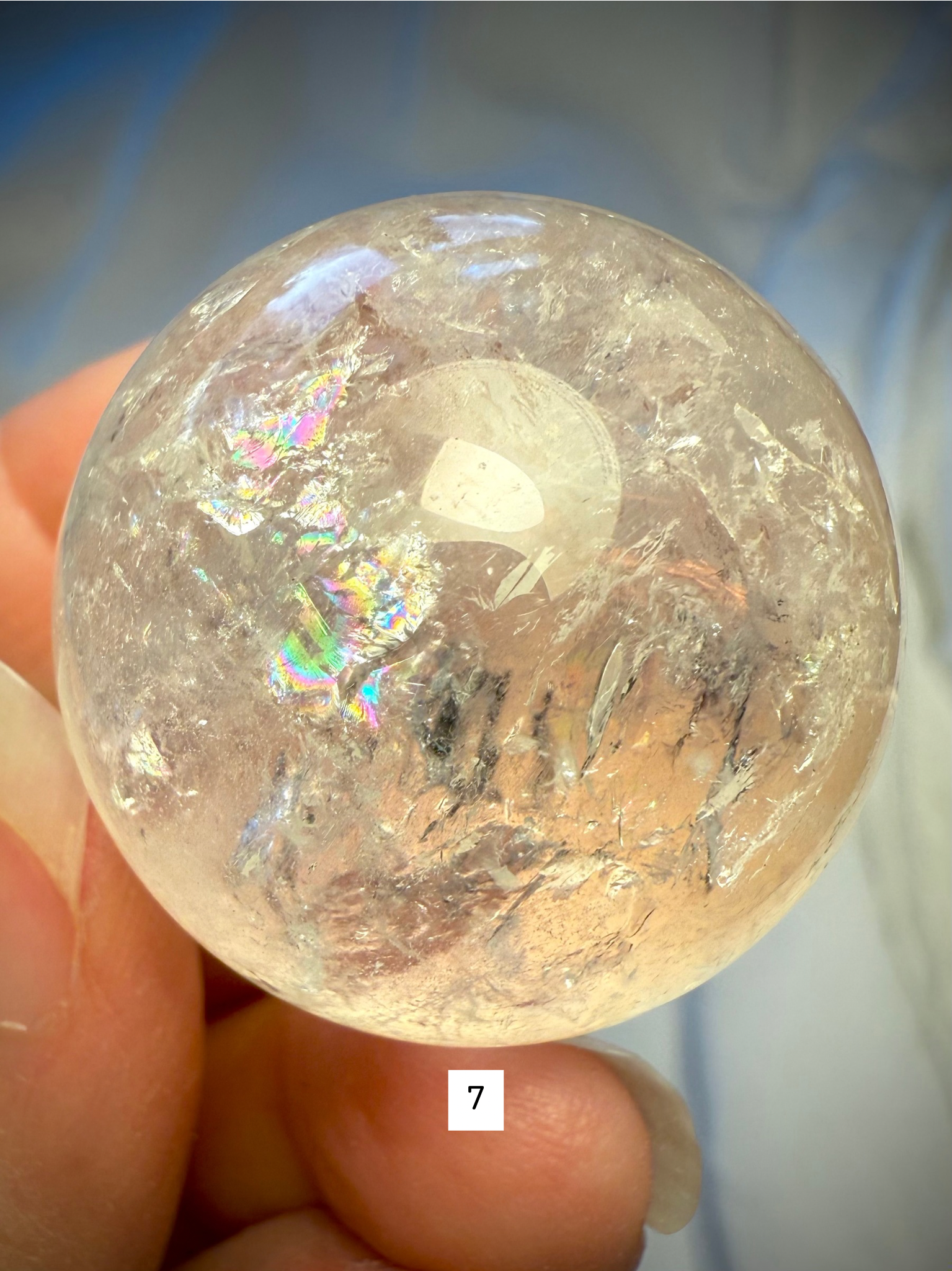 Rainbow Quartz sphere #7 glowing with radiant inner color, ideal for meditation and chakra alignment work.