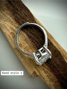 side view of option 2: sterling silver moon ring with adjustable band on wooden surface