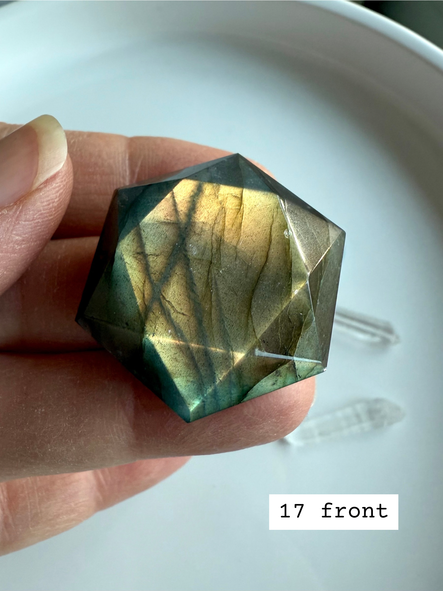 faceted labradorite hexagon with golden flash held in hand crystal star of david carving for intuition and third eye chakra