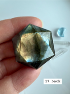 faceted labradorite hexagon with soft gold blue flash held in hand star of david labradorite crystal for spiritual insight