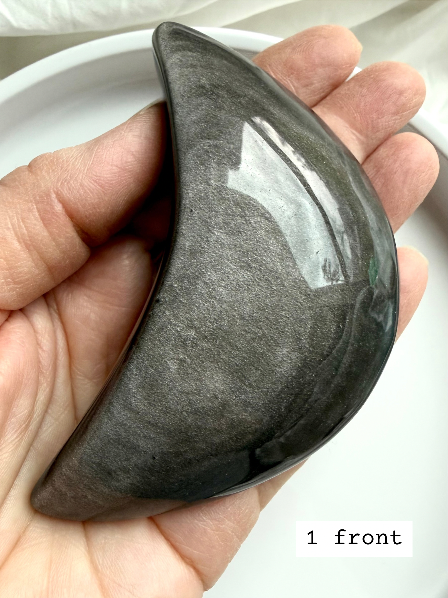 Close-up of Silver Sheen Obsidian crescent moon showing metallic silver shimmer, protective grounding crystal