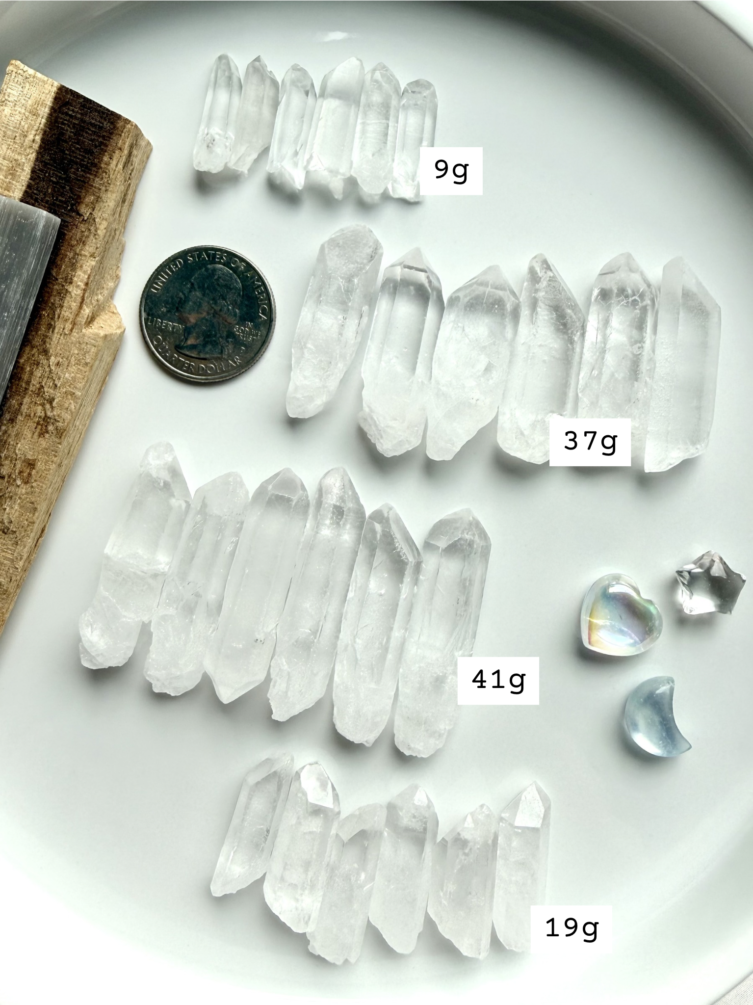 Sets of 6 small clear quartz points marked with sizes, shown with quarter for scale, natural raw quartz crystal grid stones