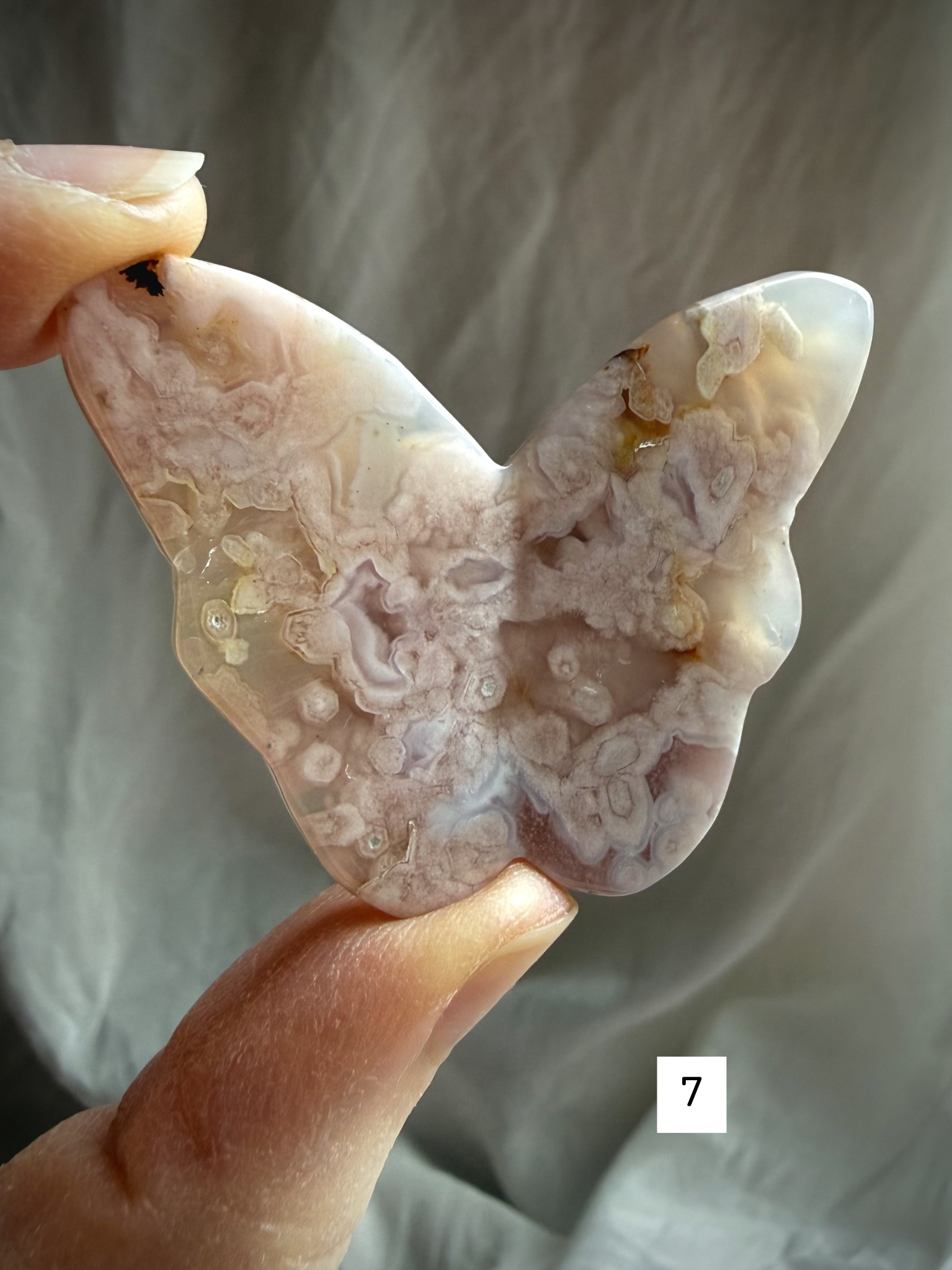 Flower Agate butterfly crystal carving #7 held in hand – detailed pink blossom agate butterfly