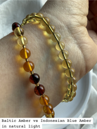 Indonesian blue amber bracelet compared with mixed color Baltic amber bracelets showing natural amber color variation