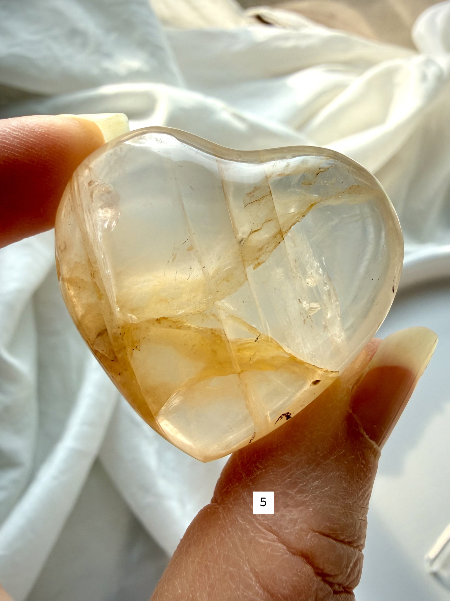 golden healer quartz heart number 5 with pale golden translucency and soft internal patterning