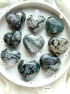 moss agate heart carvings options 1 through 9 front view choose your favorite crystal hearts with natural green inclusions and patterns