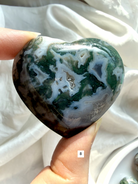 moss agate heart carving option 8 in hand with layered green inclusions and natural chalcedony pattern