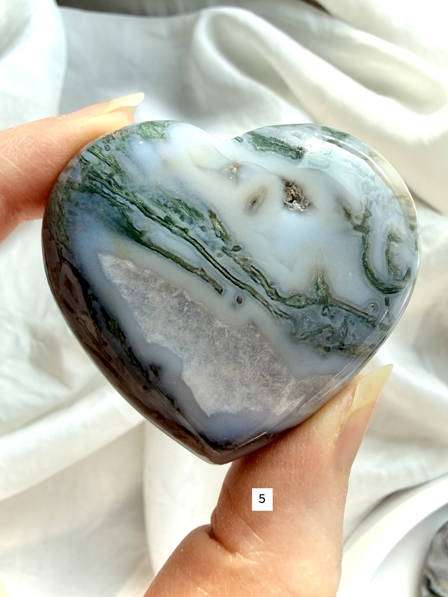 moss agate heart carving option 5 in hand with druzy pocket and layered mineral inclusions