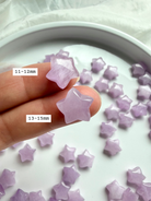 Closeup of two Kunzite stars marked with size — miniature crystal star carvings for heart chakra energy work.