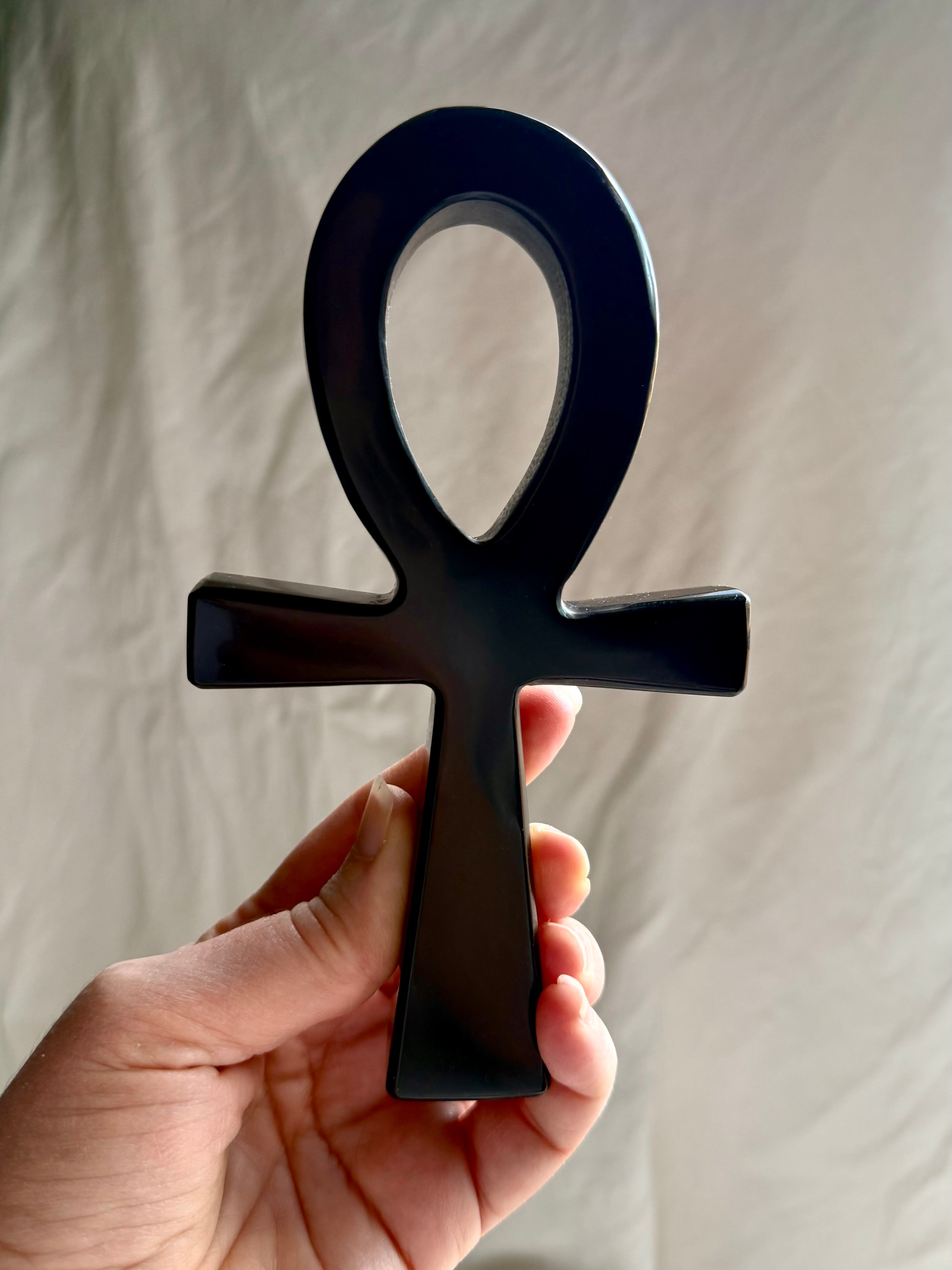 Black obsidian ankh crystal — protective talisman symbolizing life force and divine connection.