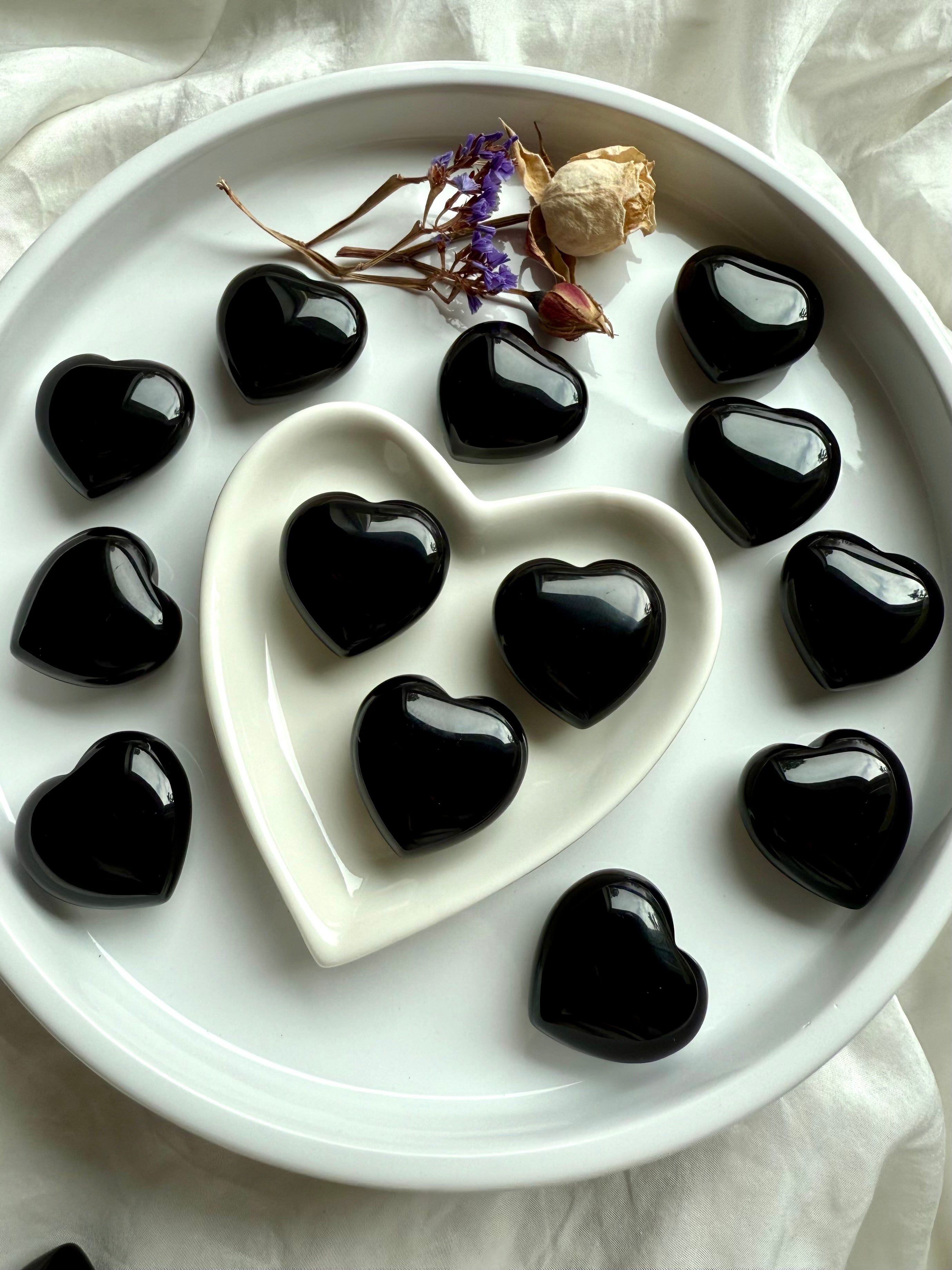 Group of Black Obsidian hearts in a ceramic heart dish — protective crystals for altar décor, energy clearing, and shadow work.