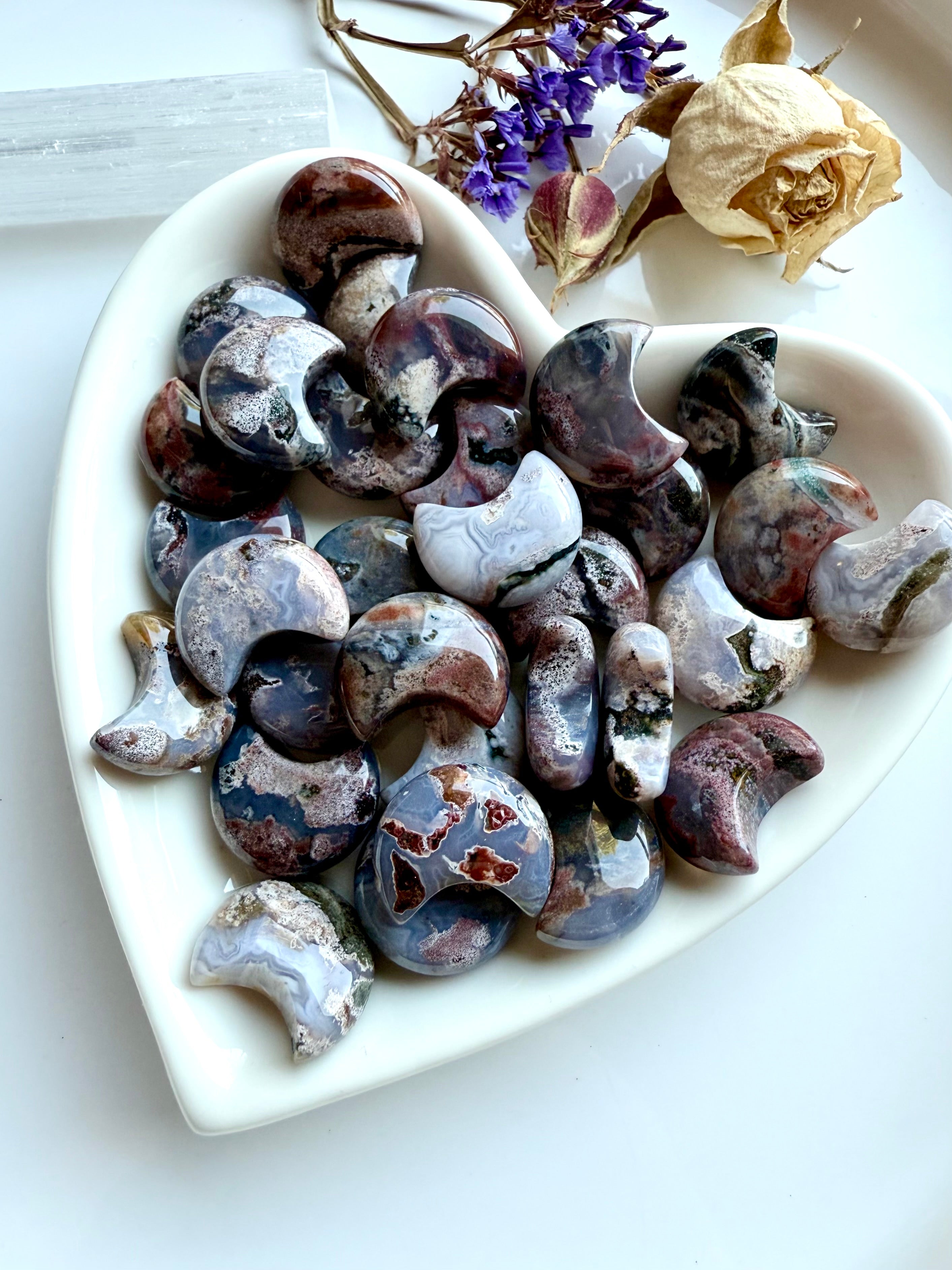 Heart-shaped dish filled with Ocean Jasper moons — mini crescent moon carvings with cosmic patterns for chakra healing and ritual use