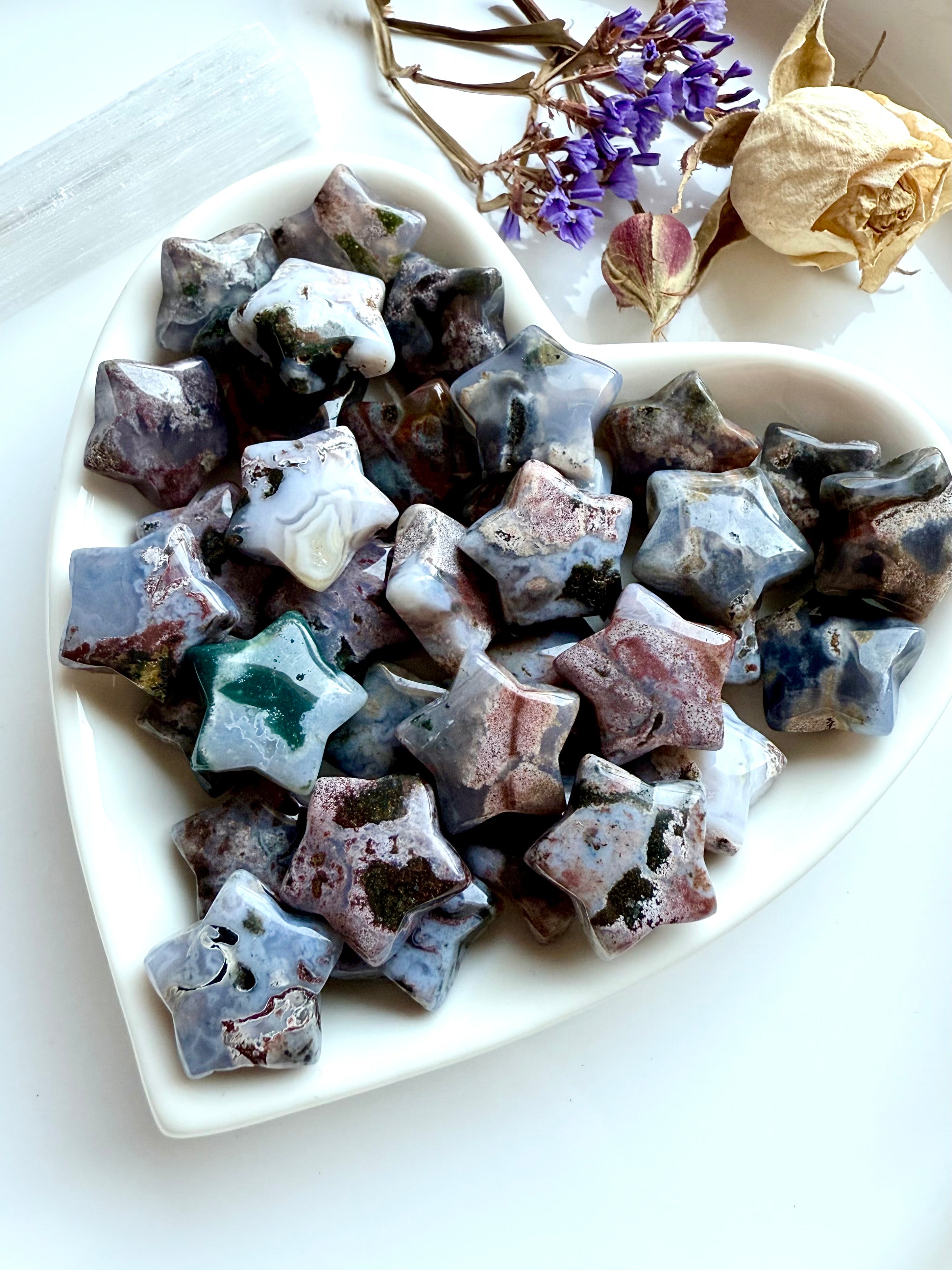 Heart-shaped dish filled with Ocean Jasper stars — crystal carvings for celestial décor, grounding, and heart chakra energy