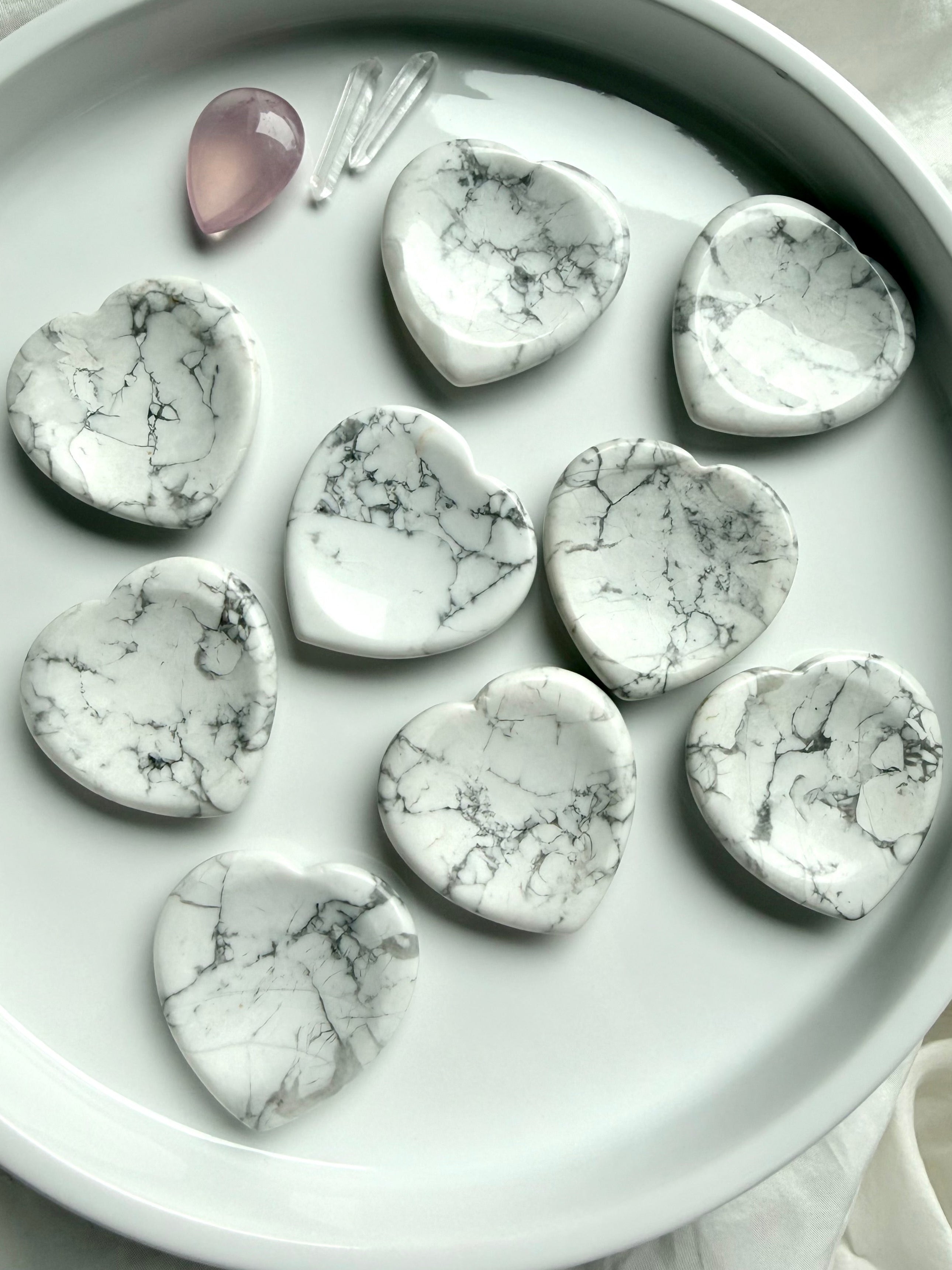 Howlite heart worry stones on white tray with natural gray veining polished thumb stones