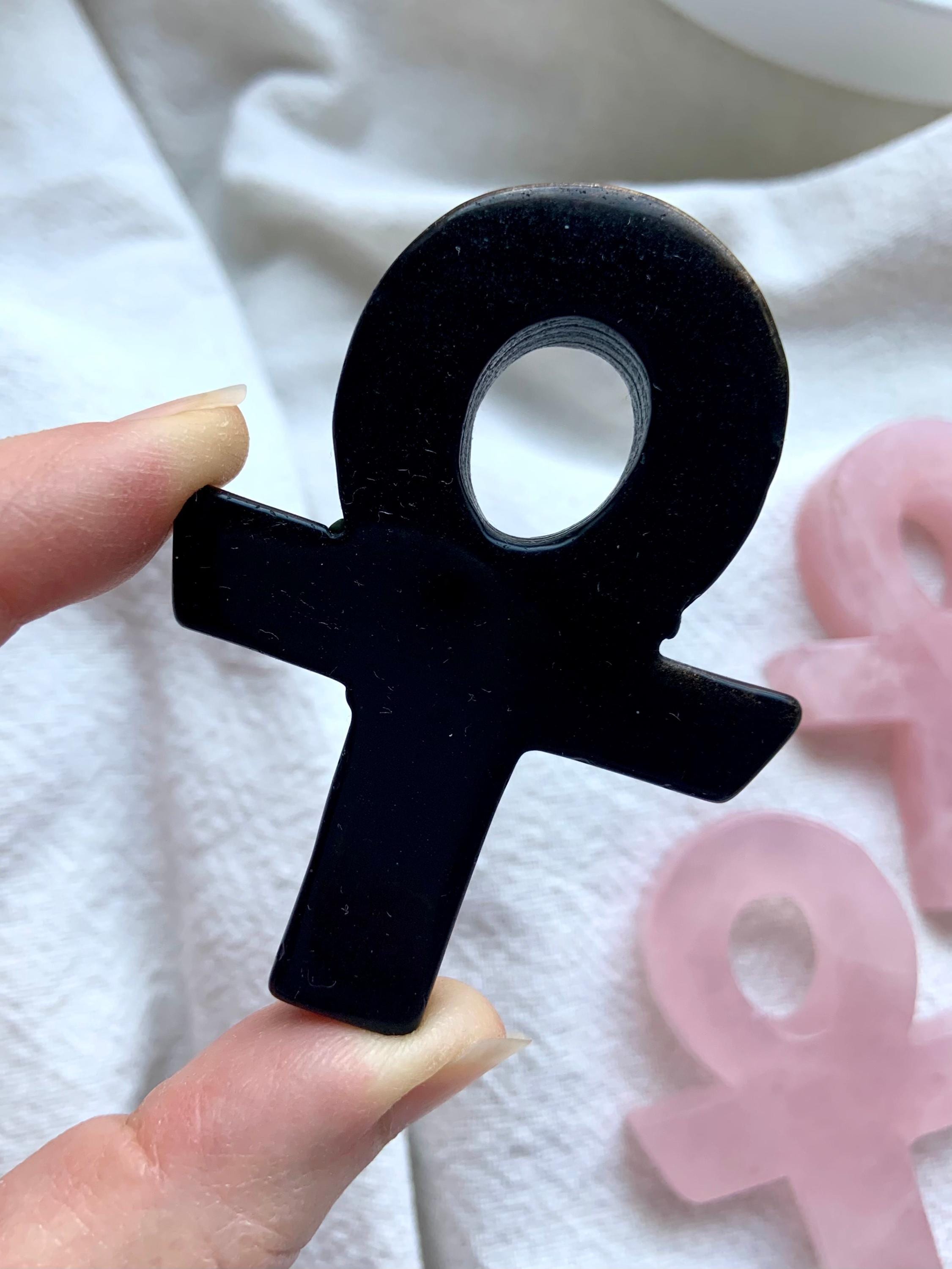 A close up view of a Hand Carved Black Obsidian Ankh, a powerful and protective meditation tool