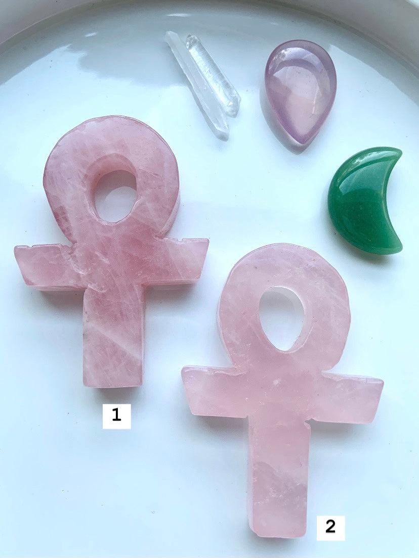 Choose your favorite Hand Carved Rose Quartz Crystal Ankh, shown on a white plate