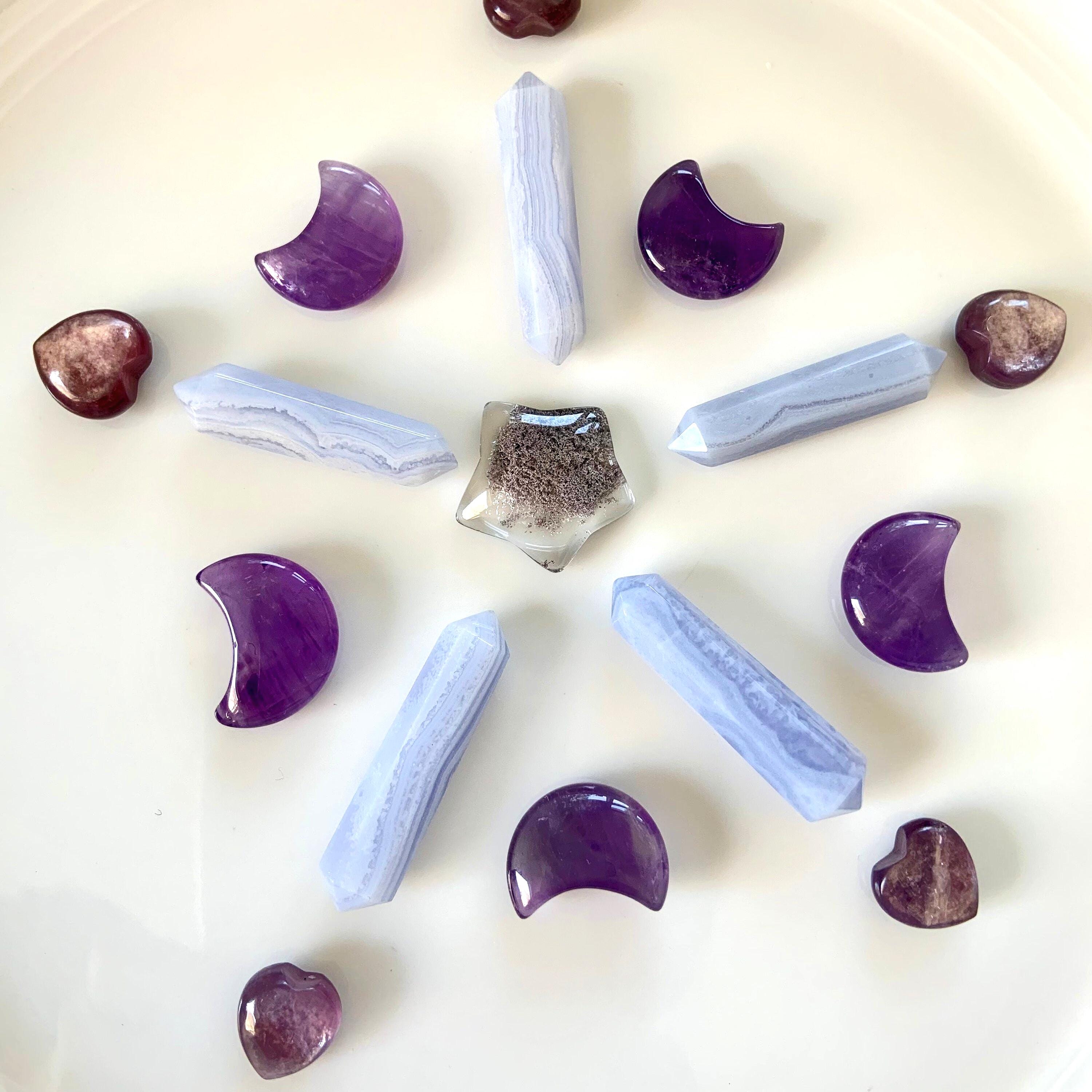 A crystal grid with amethyst moons, blue lace agate DT's, lepidolite hearts + a garden quartz star