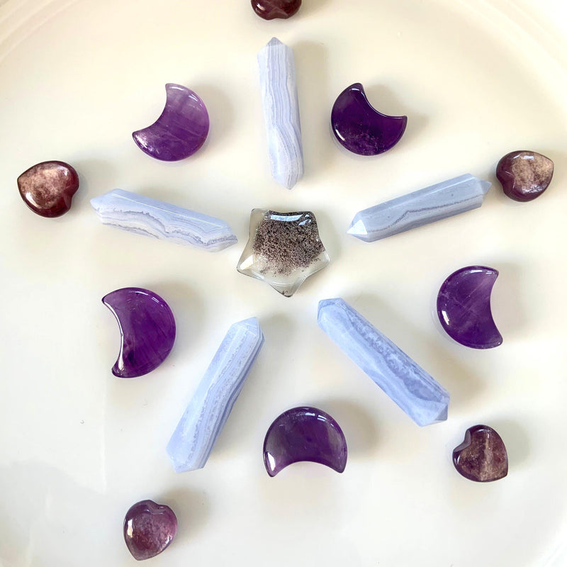 A crystal grid with amethyst moons, blue lace agate DT's, lepidolite hearts + a garden quartz star