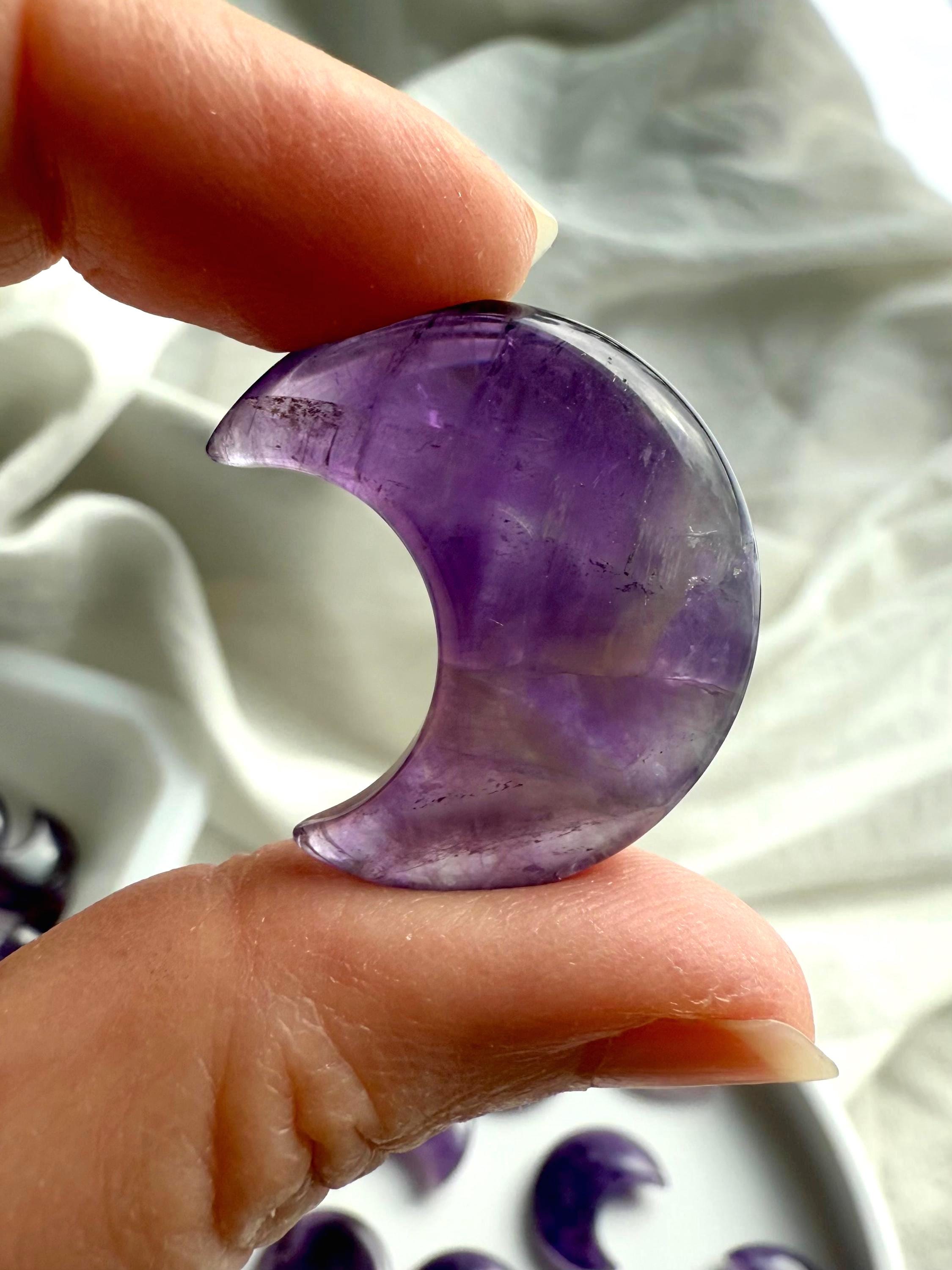 A closeup view of a dream amethyst moon with smokey quartz inclusions