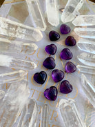 Wide angle view of Mini Amethyst hearts in a quartz point grid — powerful crystal arrangement for amplification and energy focus