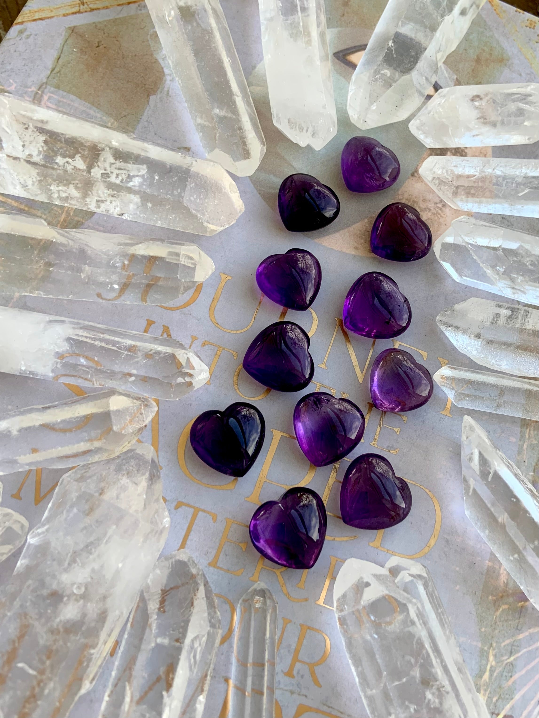 Wide angle view of Mini Amethyst hearts in a quartz point grid — powerful crystal arrangement for amplification and energy focus