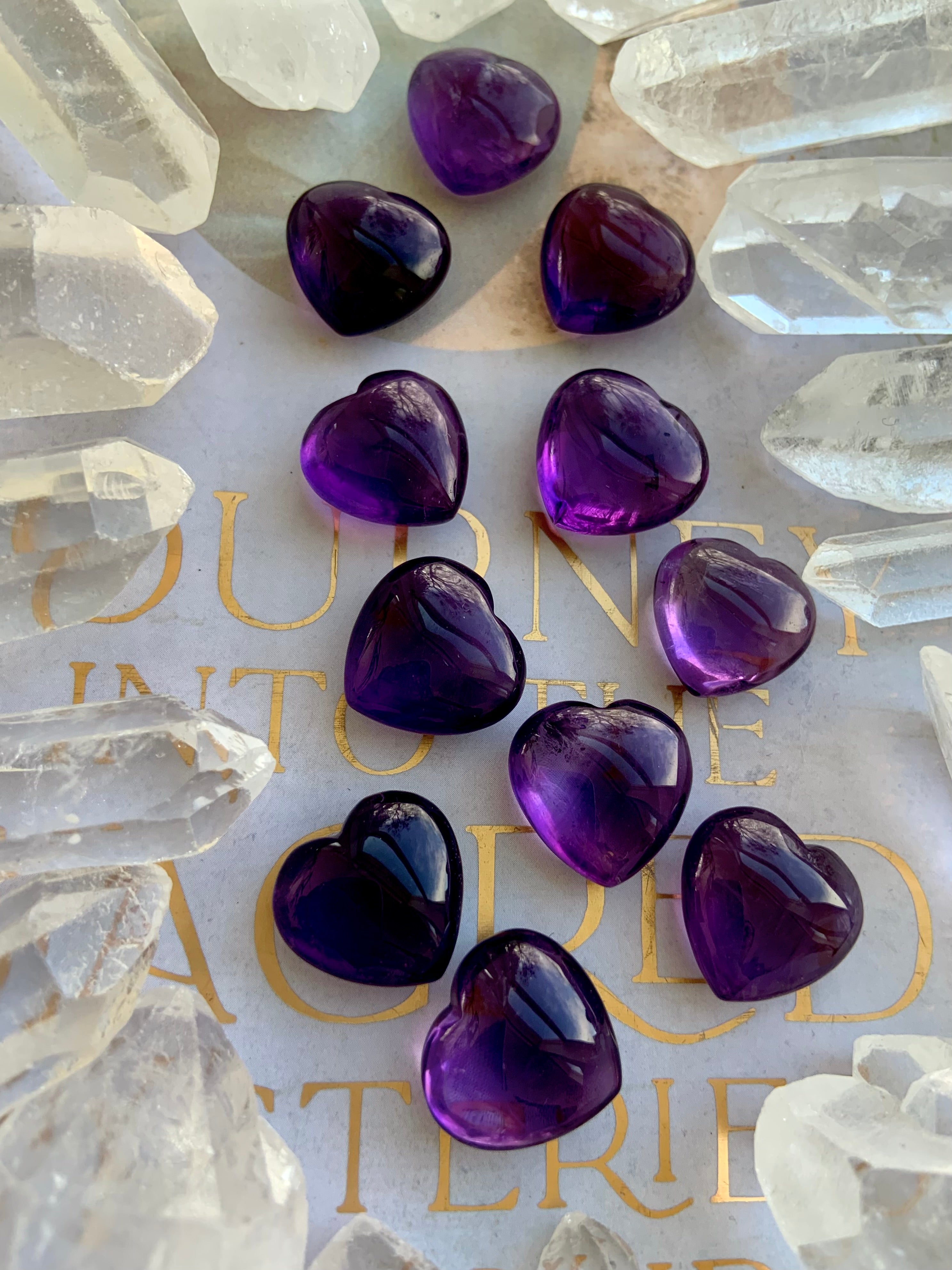 Mini Amethyst hearts surrounded by clear quartz points — purple crystal hearts for intuition and balance