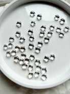 Collection of miniature Clear Quartz star crystals in a white dish, sparkling celestial gemstones for clarity, focus and intention setting