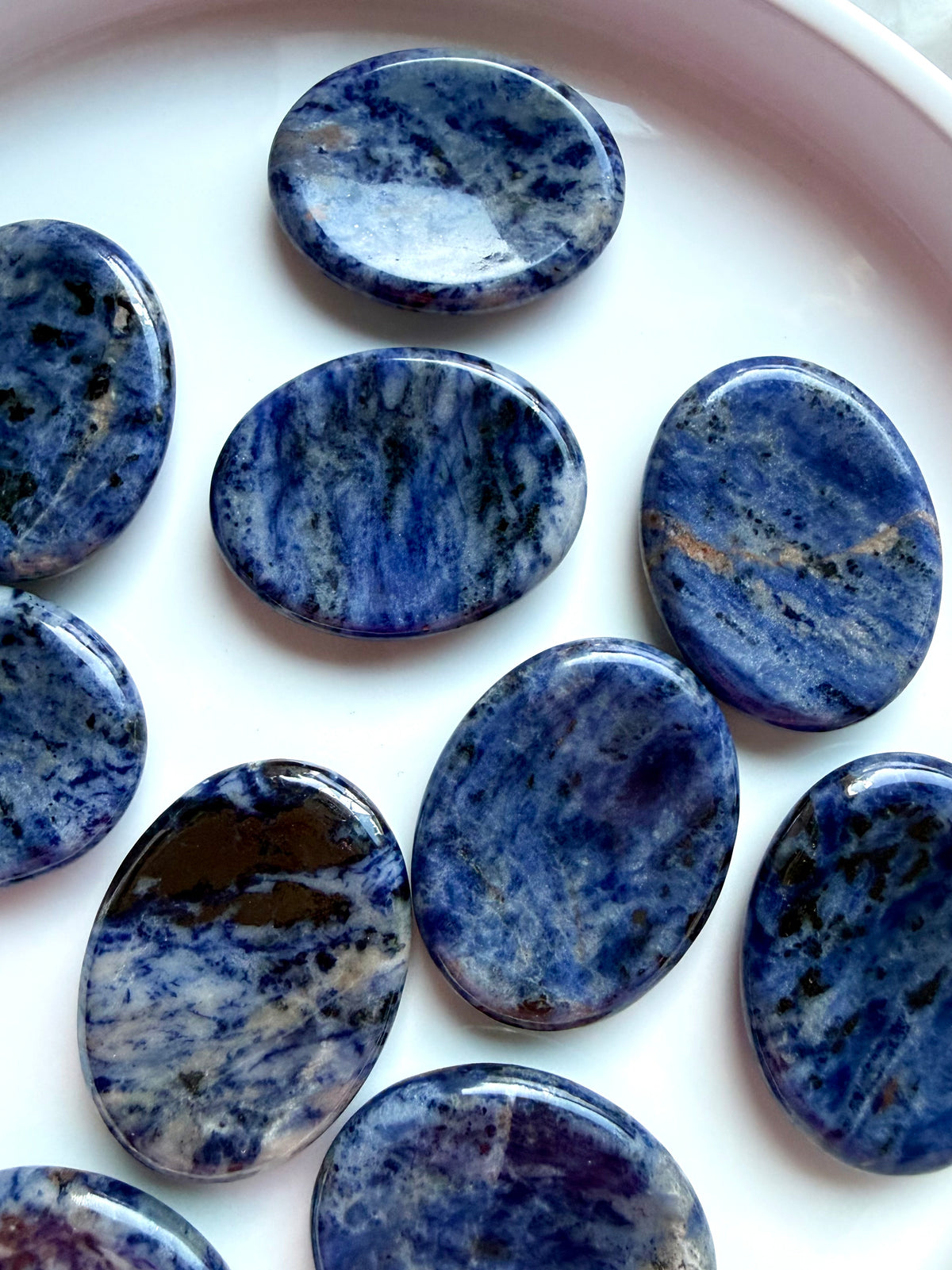 Natural blue Sodalite worry stones with varied mineral patterns and glossy polished surfaces, healing crystals for communication and intuition