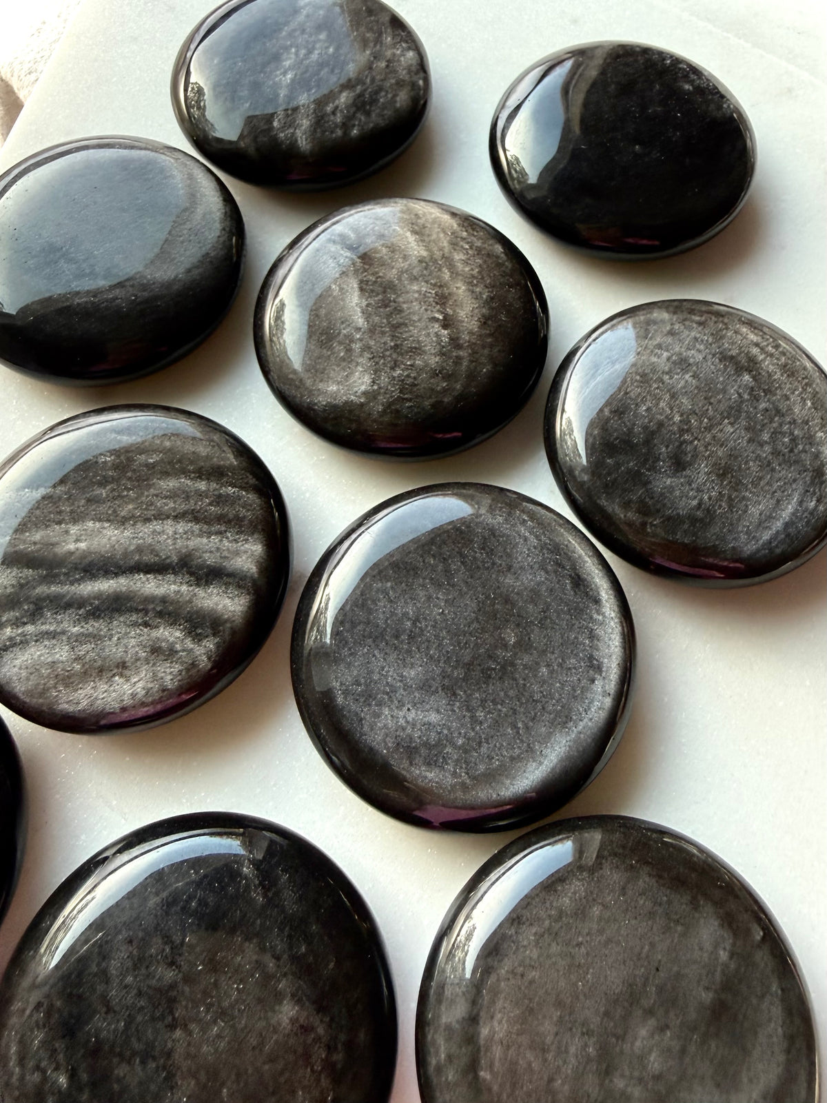 Polished round Silver Sheen Obsidian crystals with distinctive silver sheen for grounding and protection