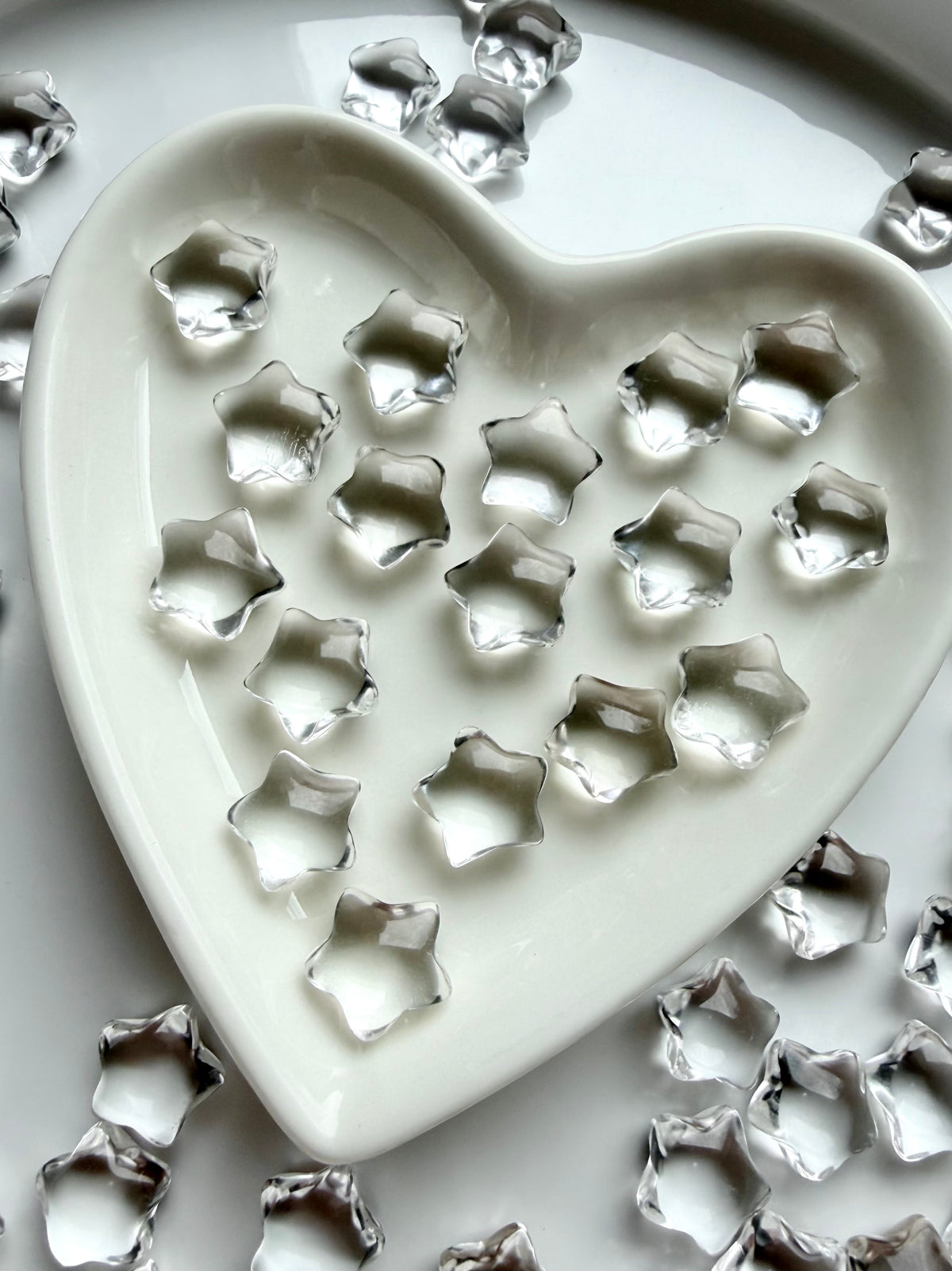 Clear Quartz stars arranged in a heart-shaped crystal dish, tiny transparent gemstones for crystal grids, cleansing rituals and altar displays