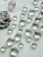 Natural Clear Quartz crystal stars arranged with other gemstones, miniature celestial carvings for crystal grids, moon rituals and altar decor